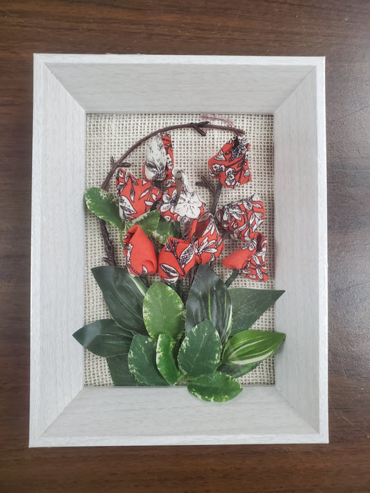 Handmade flowers with Red flower and green leaves, put them in a picture frame, flowers are made of fabric.