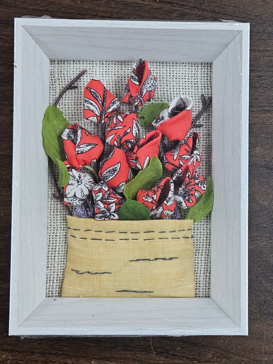 Handmade flowers with Red flower pots and green leaves, put them in a picture frame, flowers are made of fabric.