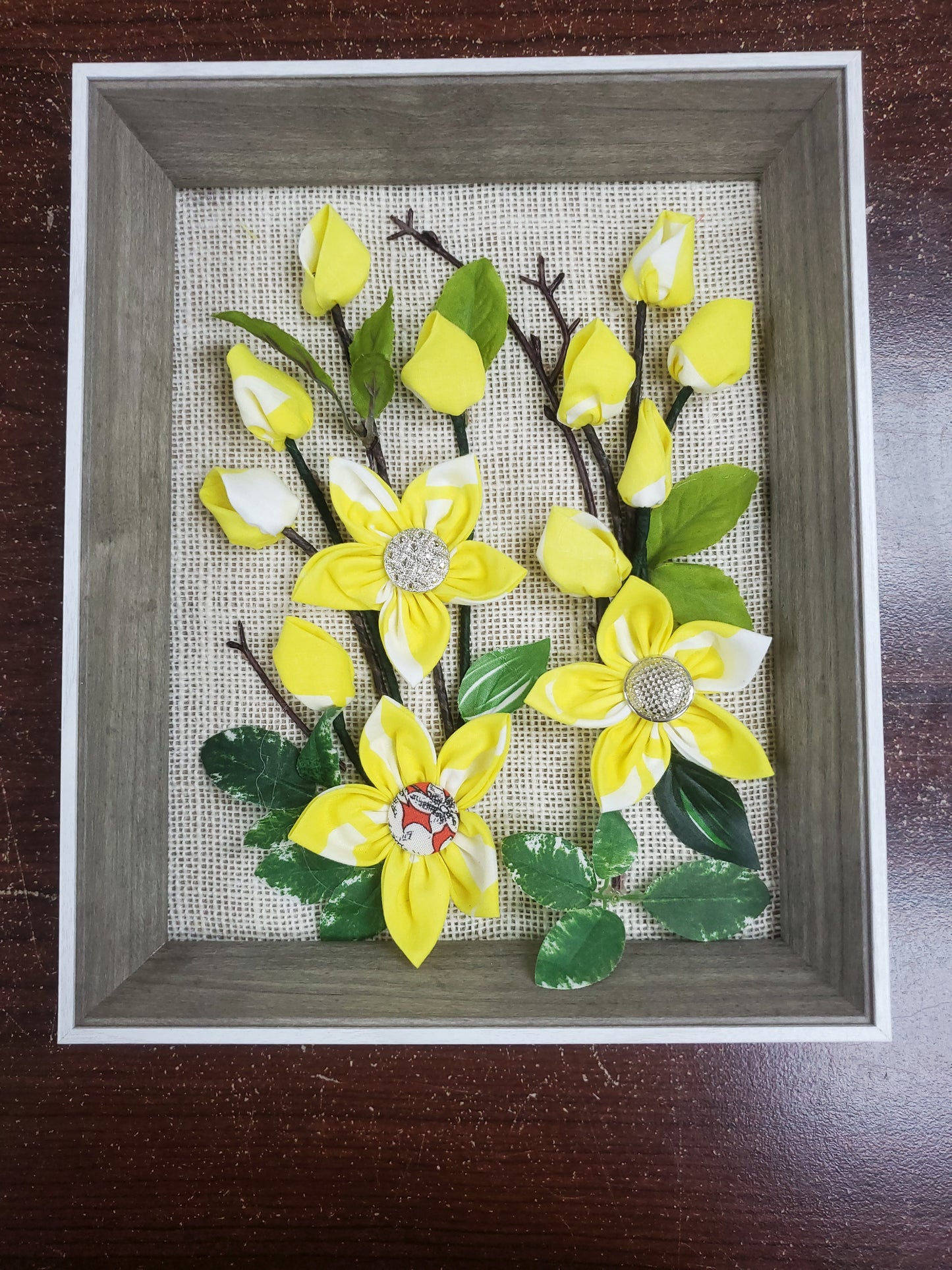 3D Handmade fabric flowers and green leaves,Luxury button decorated with flowers put them in a picture frame, flowers are made of fabric.