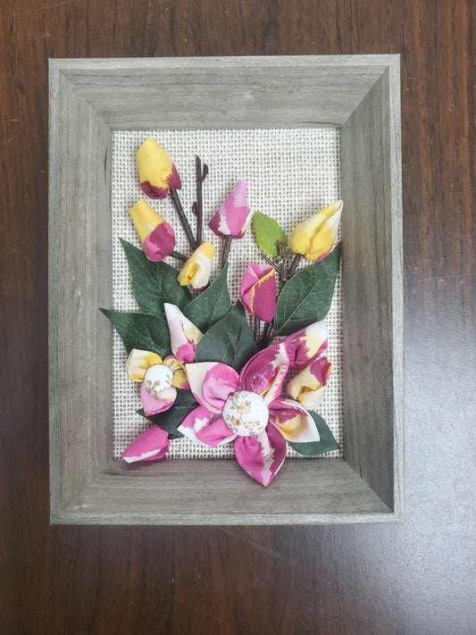 Handmade flowers pots and green leaves, put them in a picture frame, flowers are made of fabric.