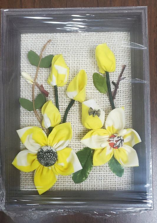 3D Handmade fabric flowers and green leaves, put them in a picture frame, flowers are made of fabric.